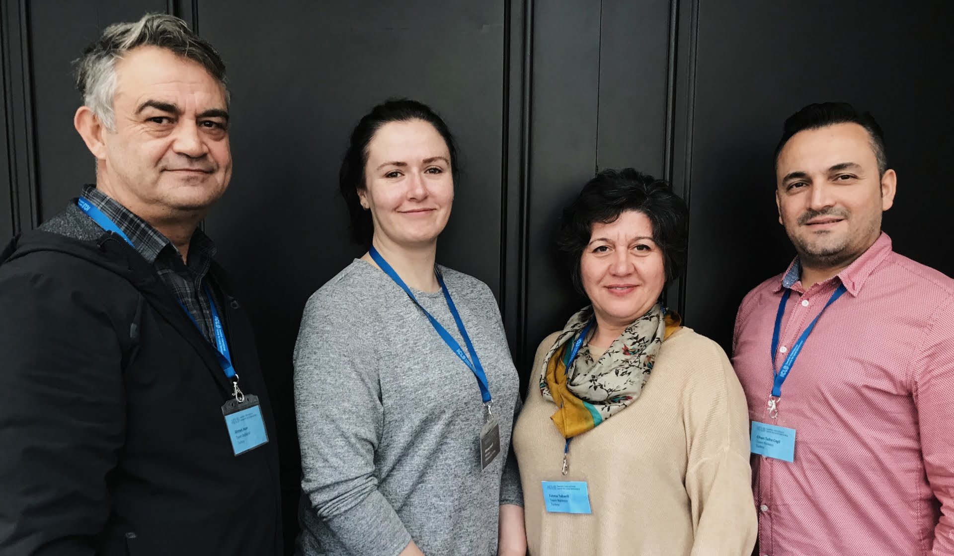 Four people - two men and two women - standing