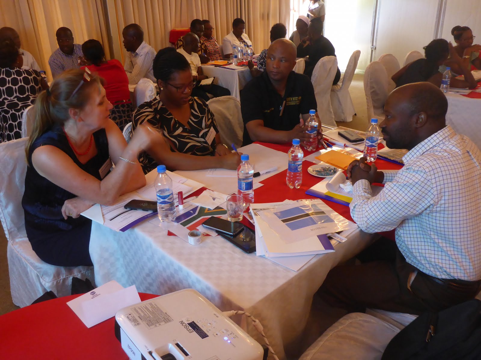 Men and women at a table talking to each other